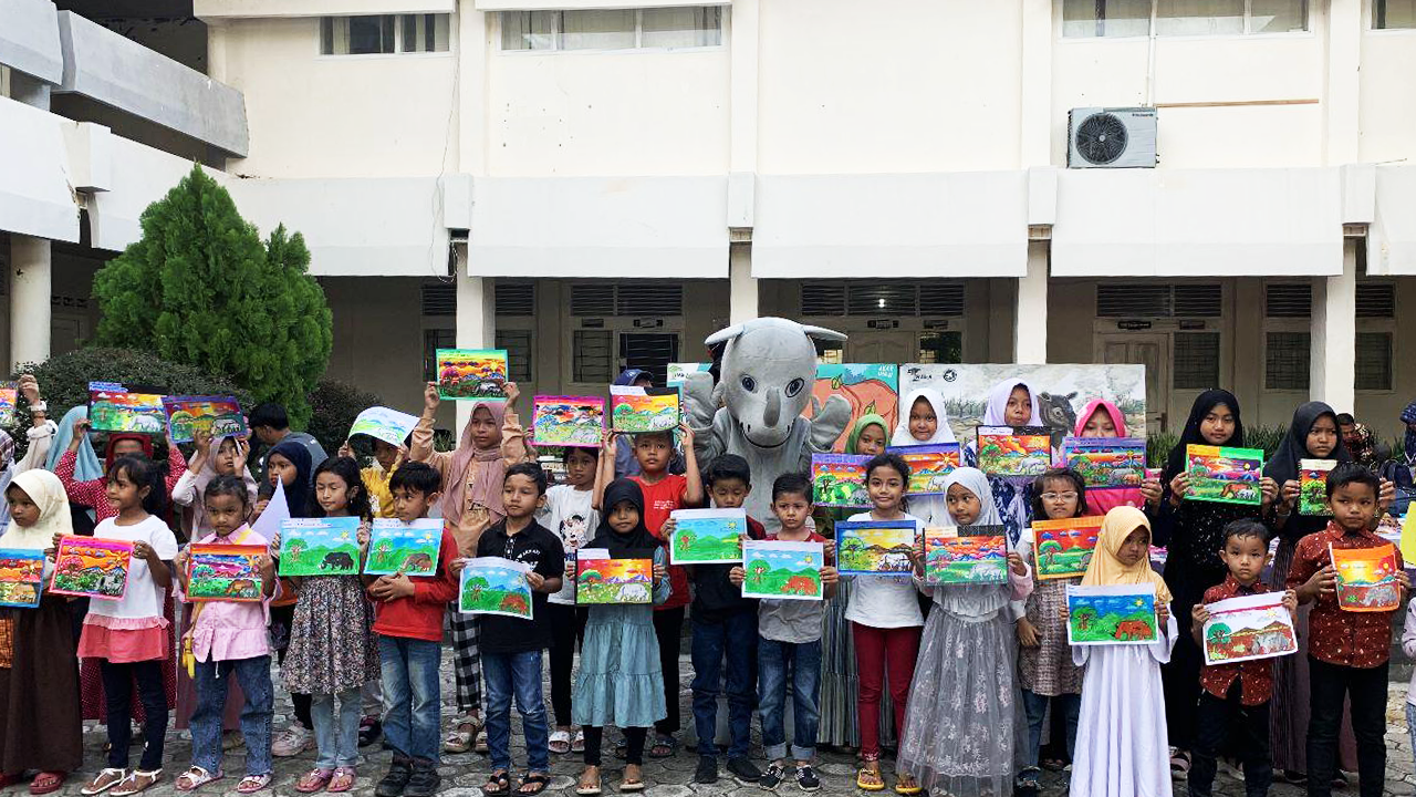 Students posing with rhino